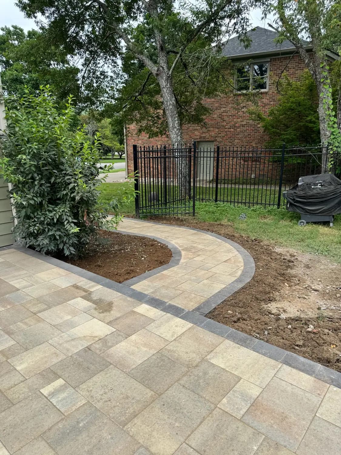 Curved paver walkway with a contrasting border course