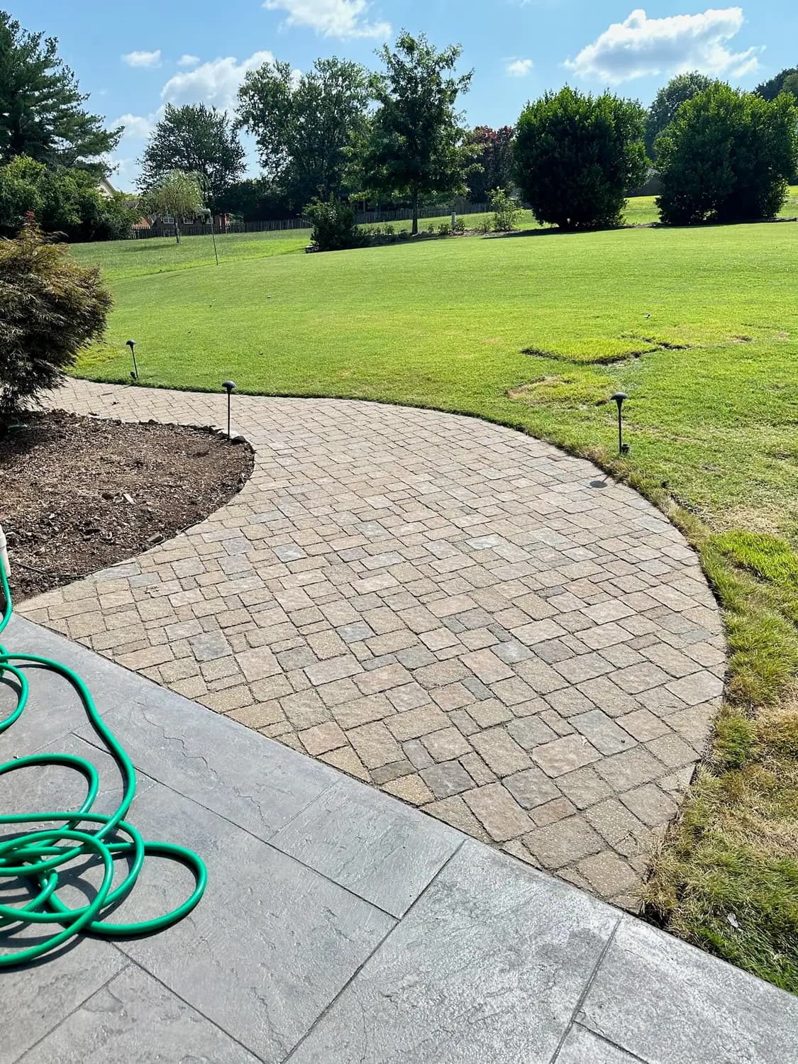 Curved paver walkway with low-voltage path lighting
