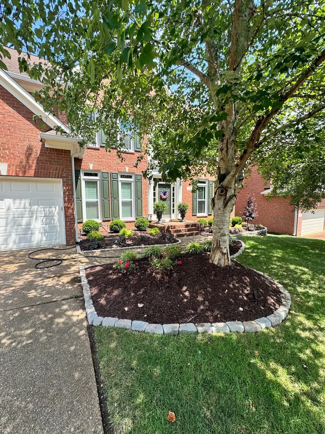 Front landscape bed with a cobblestone border