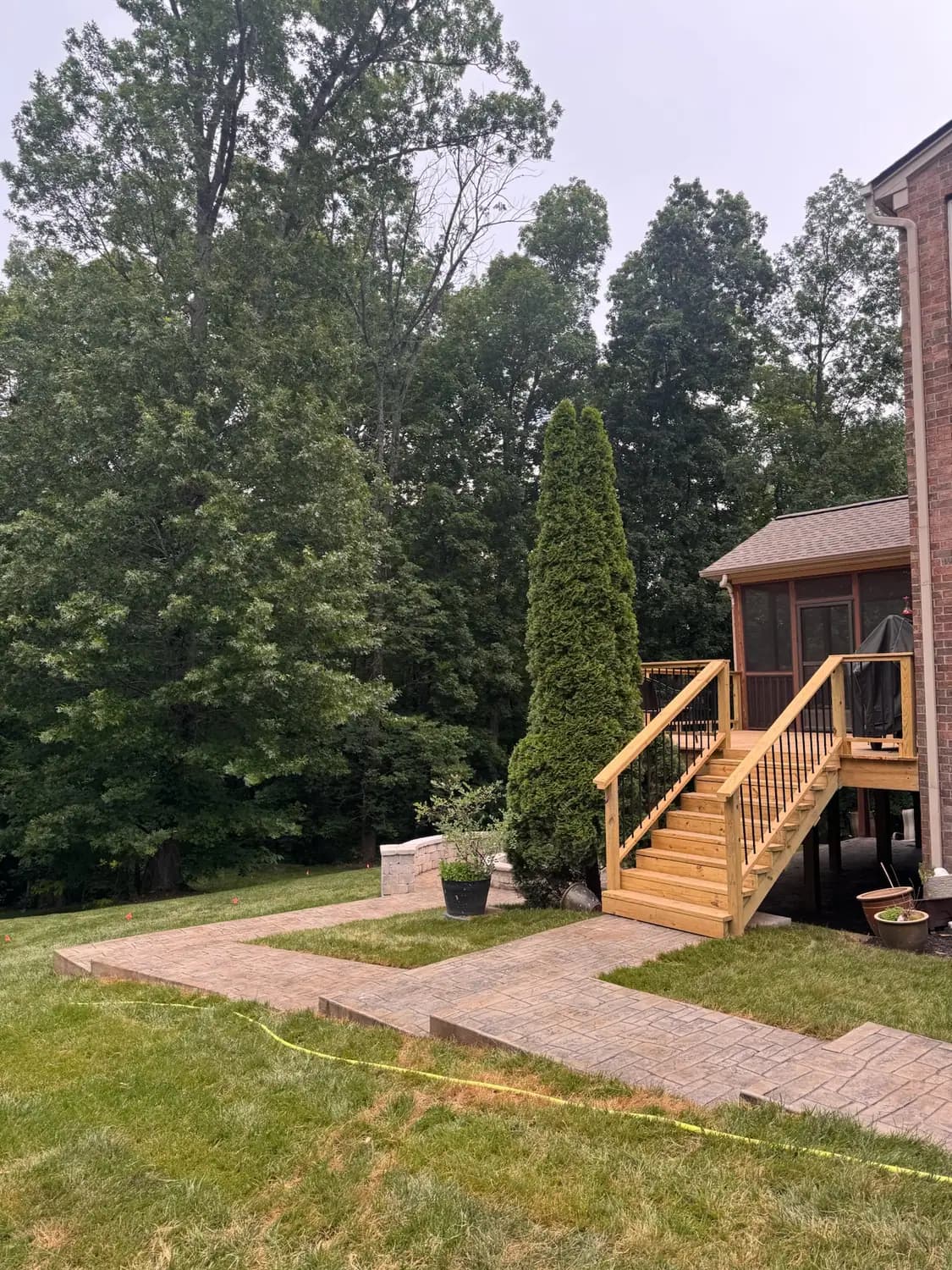 Seat wall and paver walkway leading to deck stairs