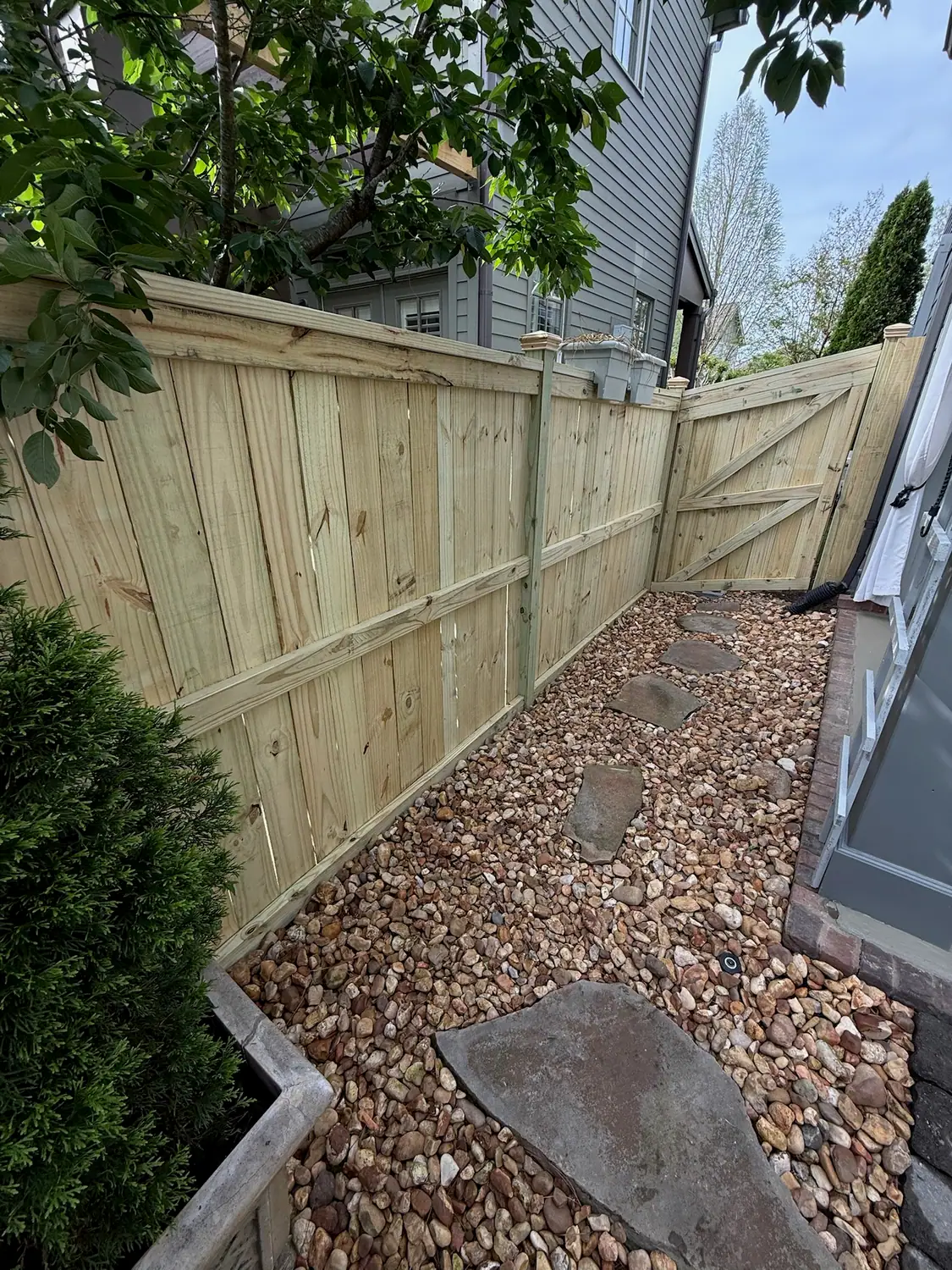 River rock drainage bed with flagstone steppers