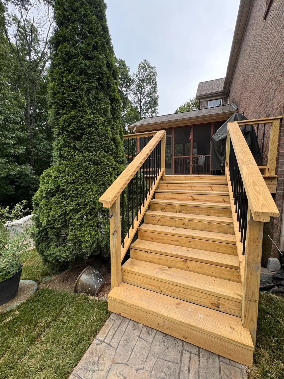 Stamped concrete patio meeting deck stairs