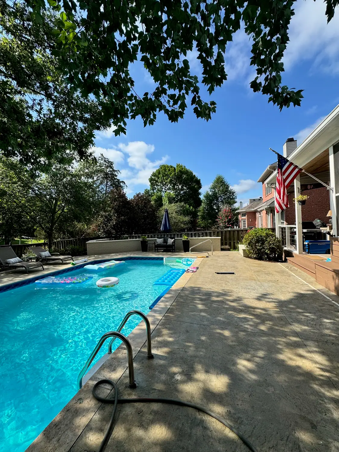 Pool surrounded by a broad concrete pool deck
